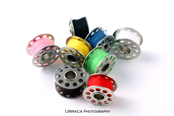Assorted Colours Thread Reels on white background