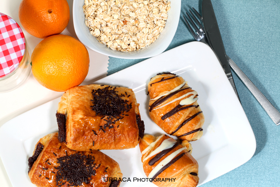 Breakfast with oat flakes oranges and chocolate buns