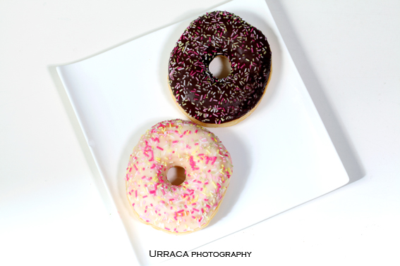 Donuts covered in black and white chocolate on a plate